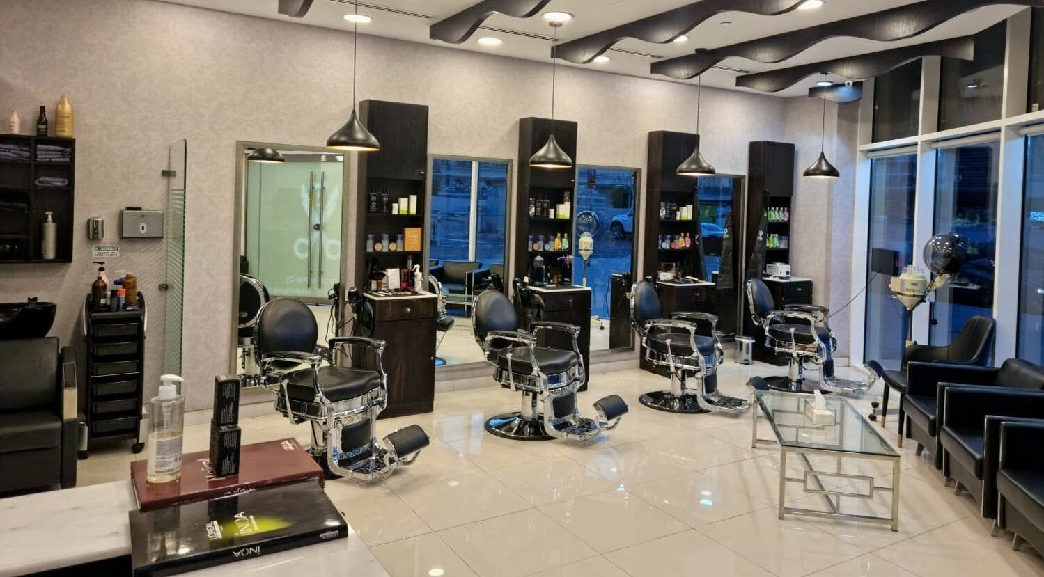 Interior of Black Tie Salon - Gent’s Spa and Barbershop, Dubai, Dubai, AE featuring modern barber chairs.