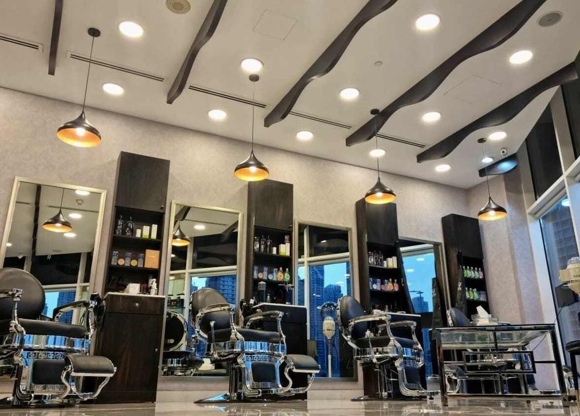 Modern interior of Black Tie Salon - Gent’s Spa and Barbershop in Dubai, Dubai, AE, featuring sleek barber chairs.