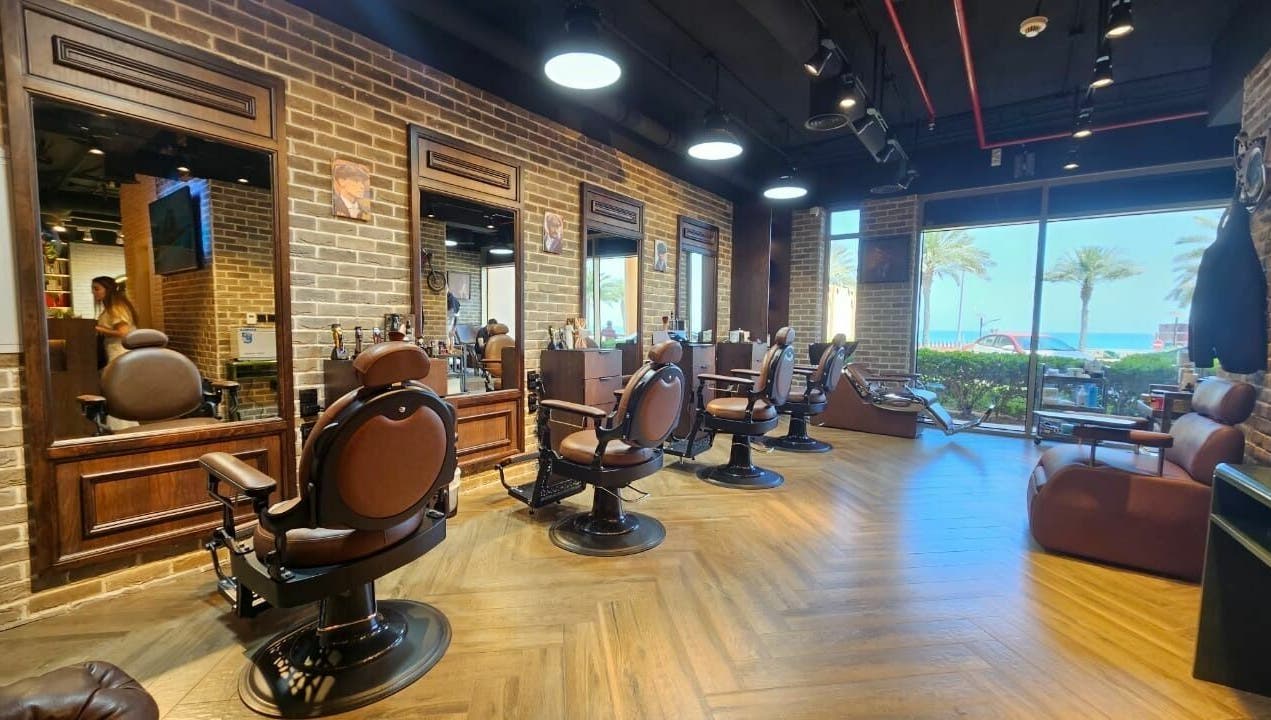 Stylish interior of Peaky Blinders | The Palm barbershop in Dubai, AE, with beachfront view.