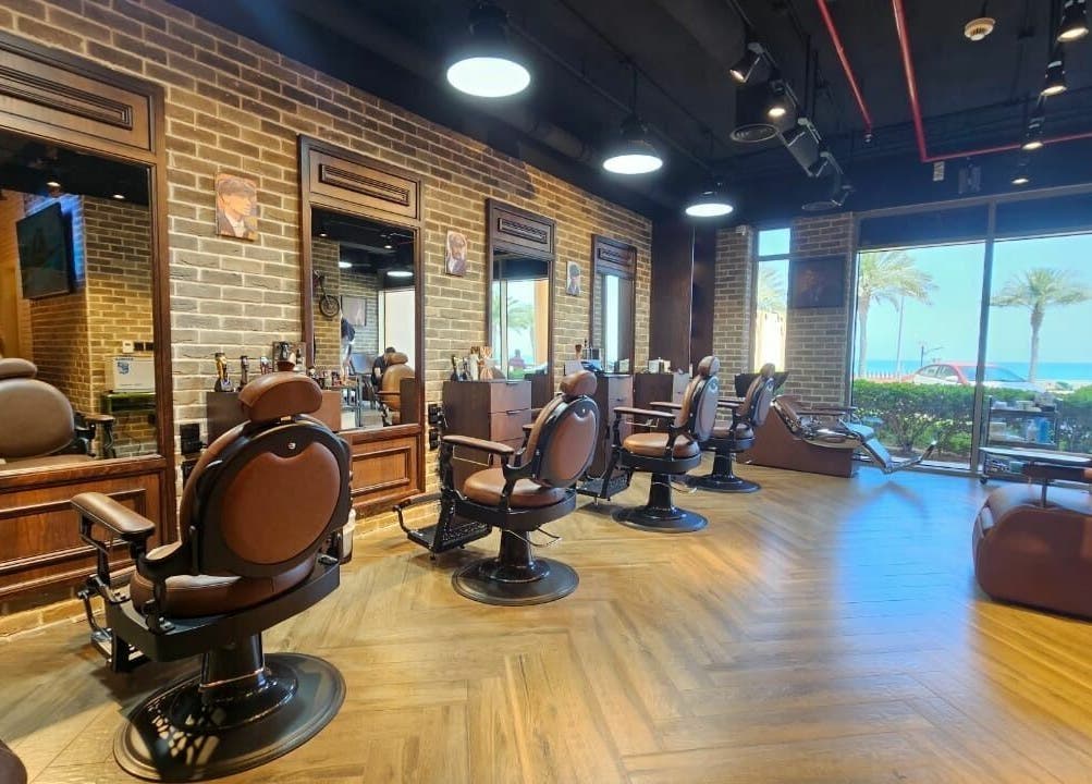 Stylish interior of Peaky Blinders | The Palm barbershop in Dubai, AE, with beachfront view.