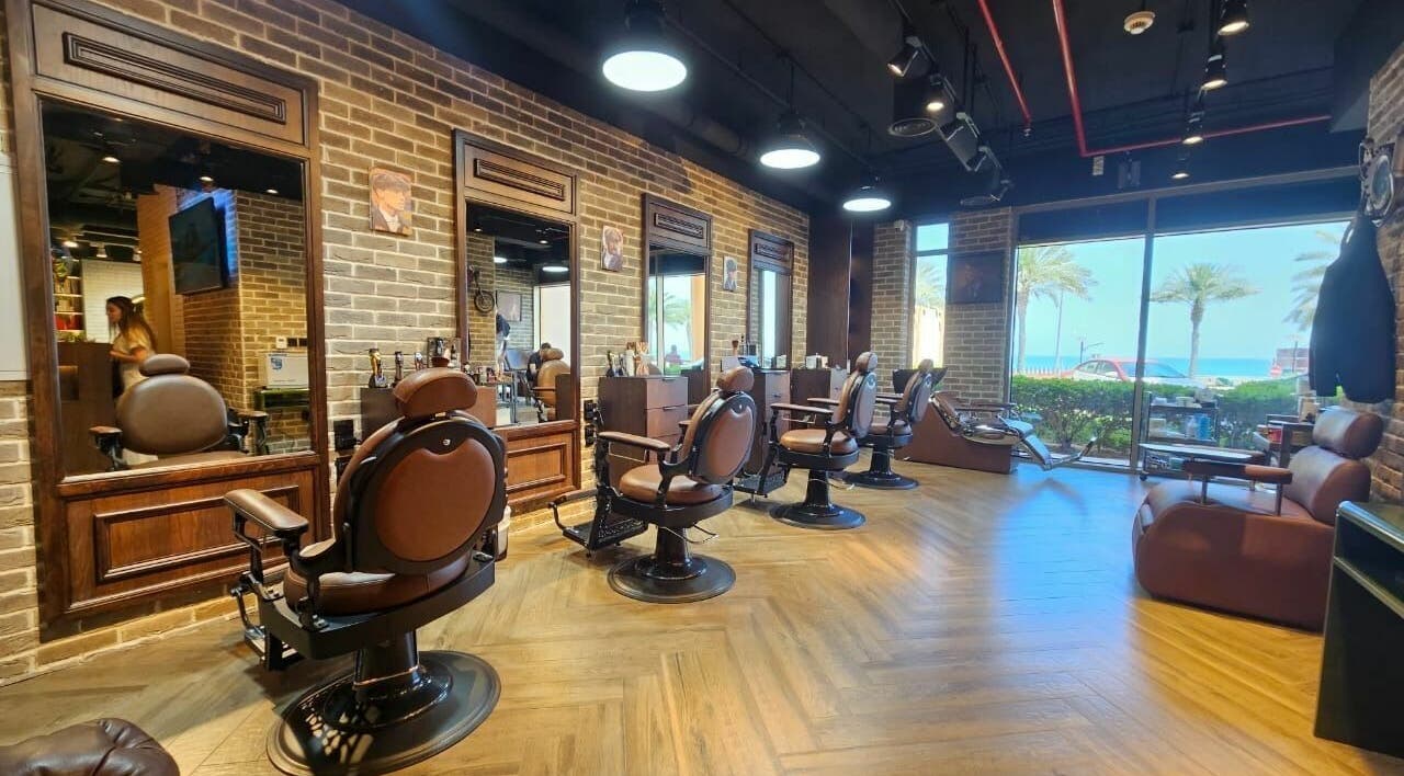 Stylish interior of Peaky Blinders | The Palm barbershop in Dubai, AE, with beachfront view.