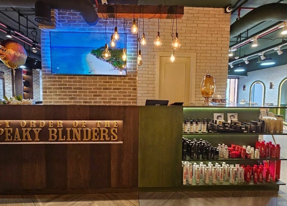 Reception area of Peaky Blinders | The Palm, Dubai, AE featuring stylish decor and beauty products.