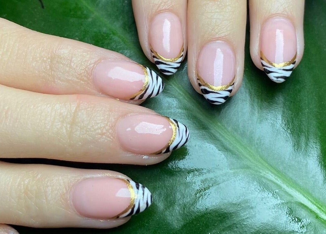 Elegant zebra nail art with gold accents at DS Beauty Salon, Banchory, Scotland, GB.