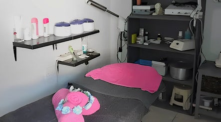 Intimate treatment room at ZiaLise Beauty Bar, Boksburg, Gauteng, ZA, featuring pink accents and skincare tools.