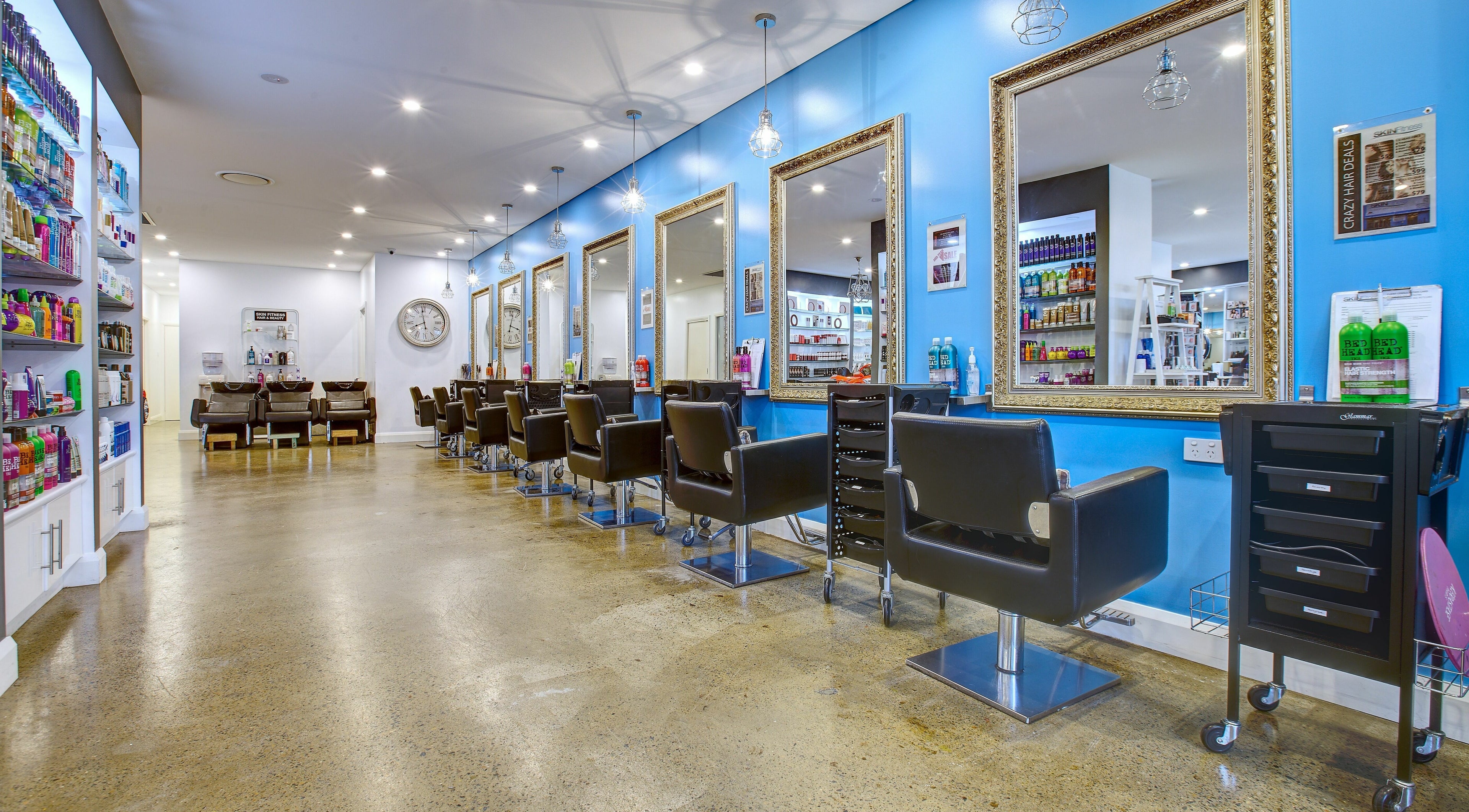 Elegant salon interior at Skin Fitness, Richmond, NSW, AU with chic styling stations and vibrant product displays.