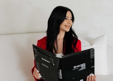 Client enjoys relaxing consultation at Hairby_maha, Windsor, Ontario, CA with fabric book in hand.