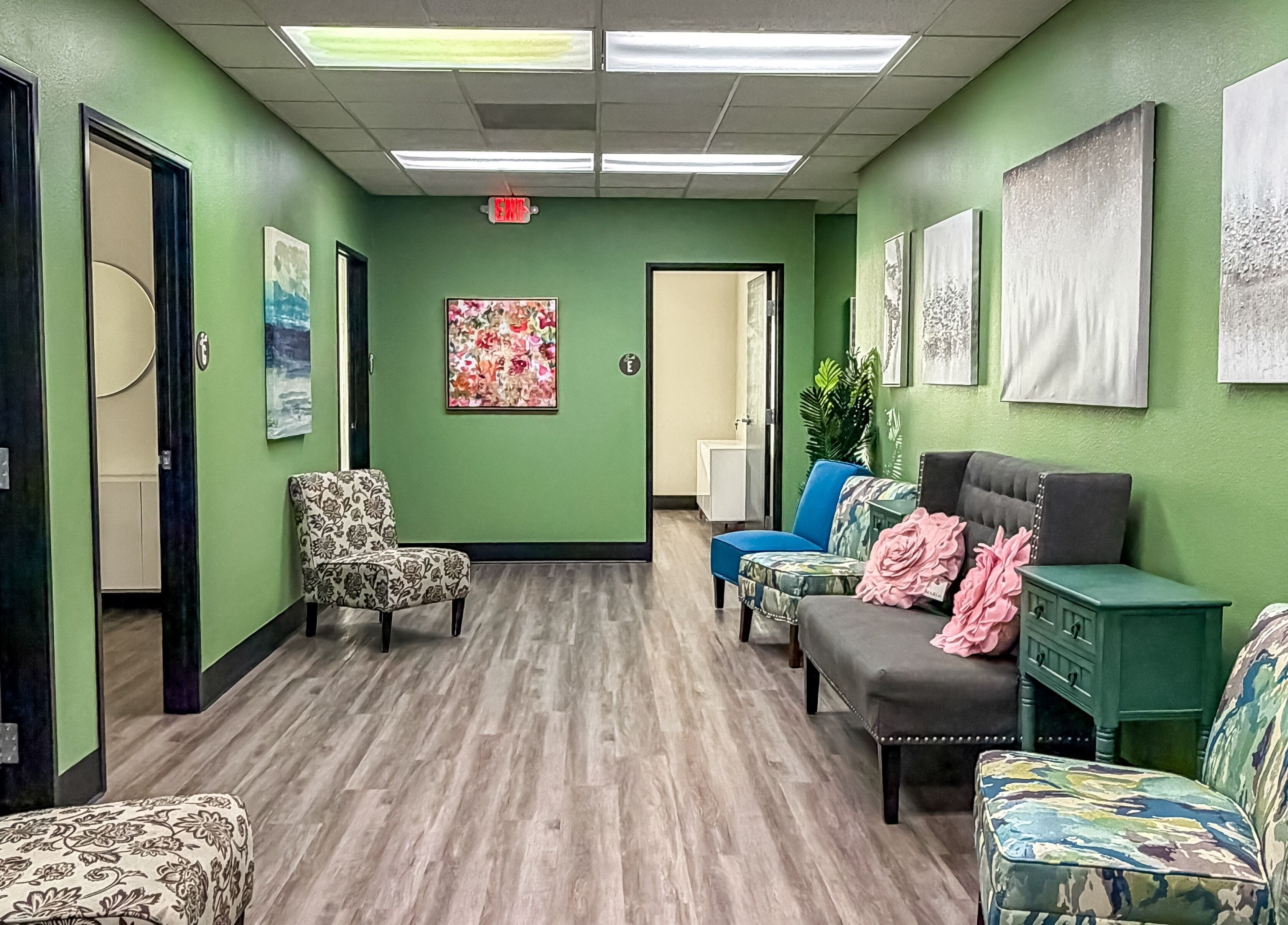 Inviting hallway with patterned chairs and art at Spa Haven Suites, Henderson, Nevada, US.
