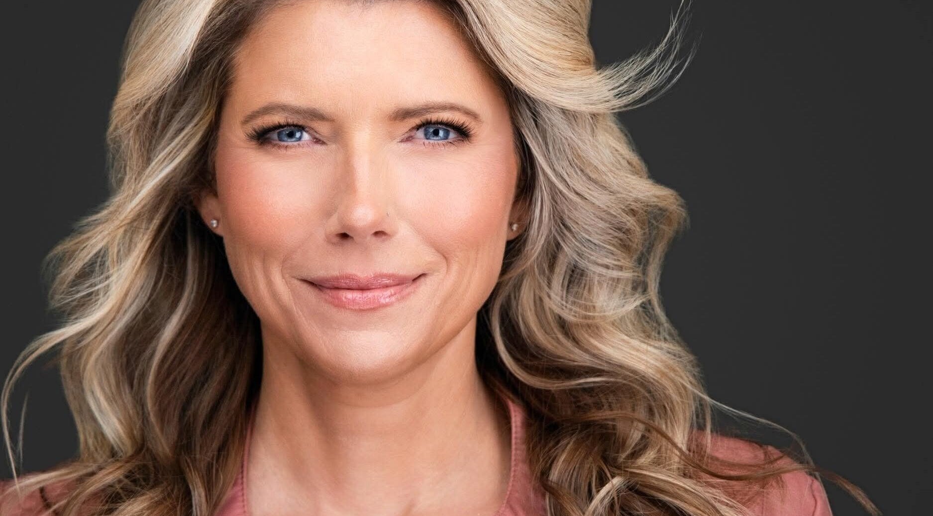 Smiling woman with styled hair at Magnolia Skin Therapy in Henderson, Nevada, US.