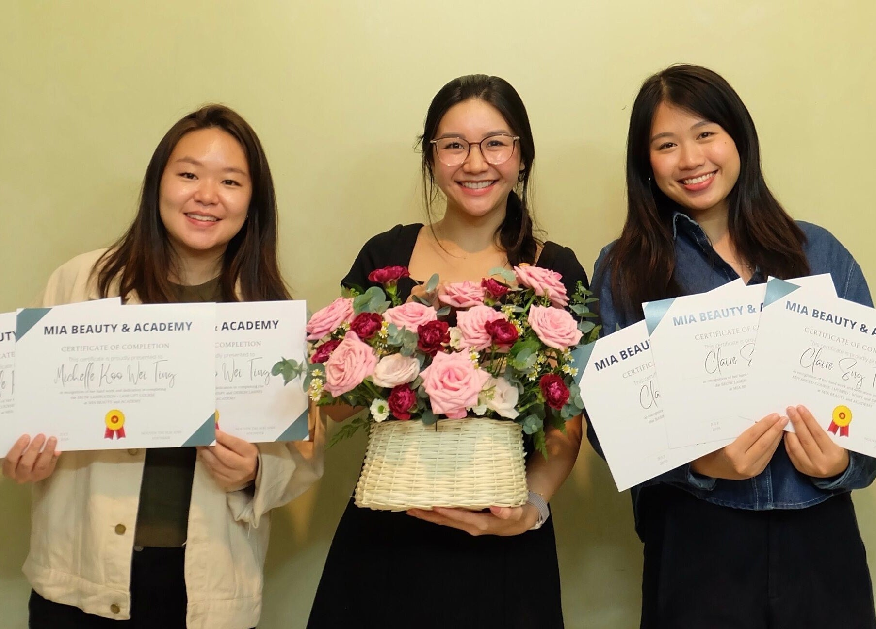Graduates hold certificates at MIA Beauty & Academy, Thành phố Hồ Chí Minh, VN, showcasing their achievements.