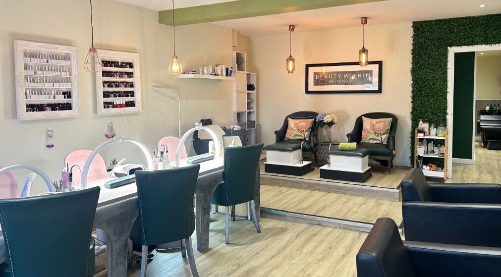 Relaxing interior of Beauty Within, Manchester, England, GB. Elegant nail stations and cozy seating.