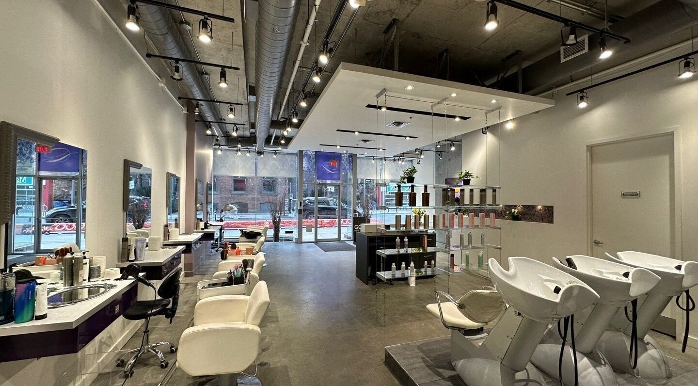 Modern interior of GOA Hair Salon Richmond St W in Toronto, Ontario, CA with stylish chairs and decor.