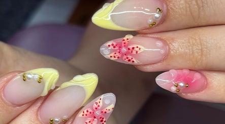 Elegant floral nail art at Nails By Molly in Maxey, England, GB, featuring intricate gel designs and embellishments.