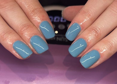 Stylish blue nails at Nails By Molly, Maxey, England, GB showcasing a glossy manicure finish.