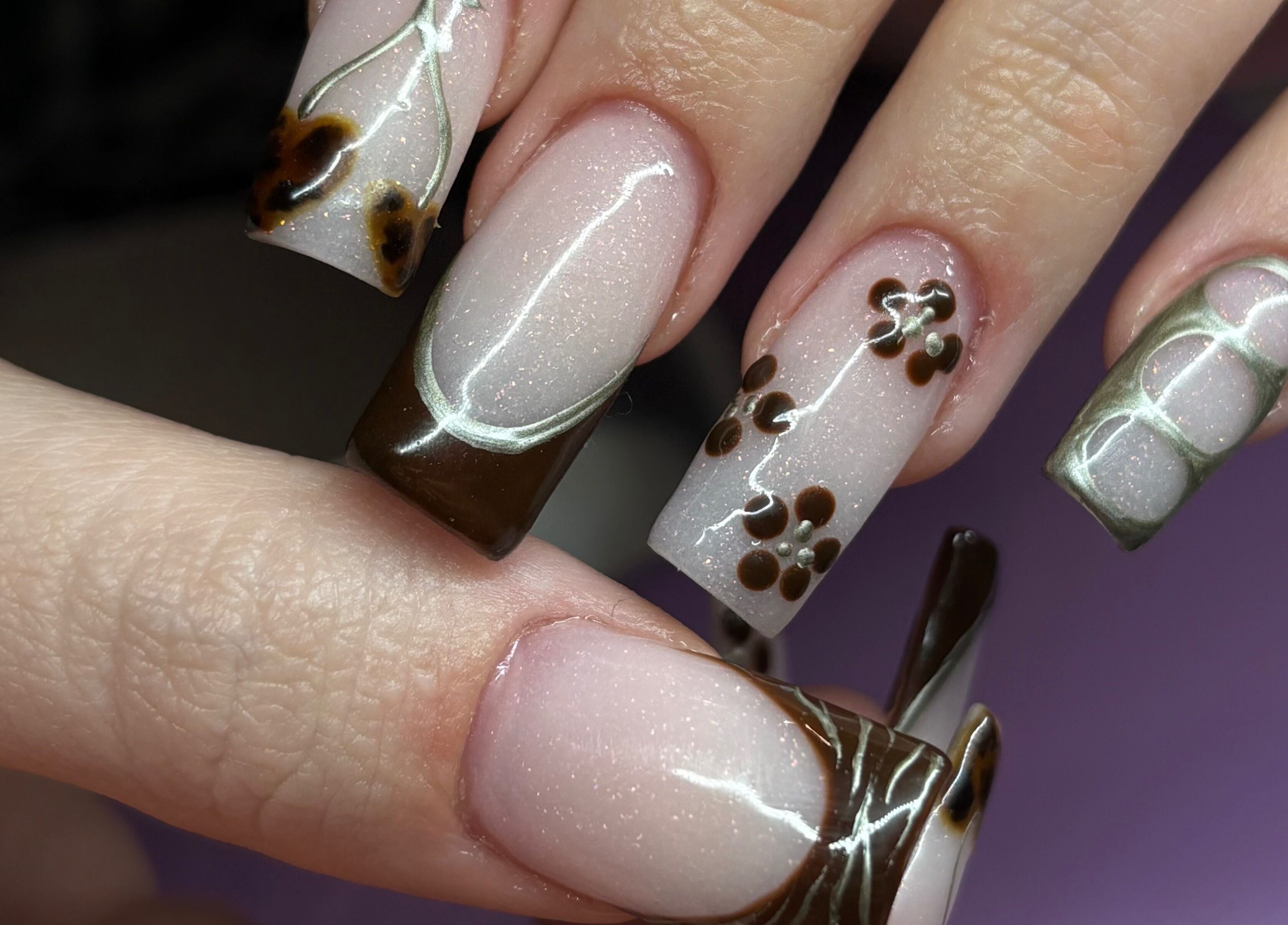 Elegant brown and floral nail design at Nails By Molly, Maxey, England, GB.