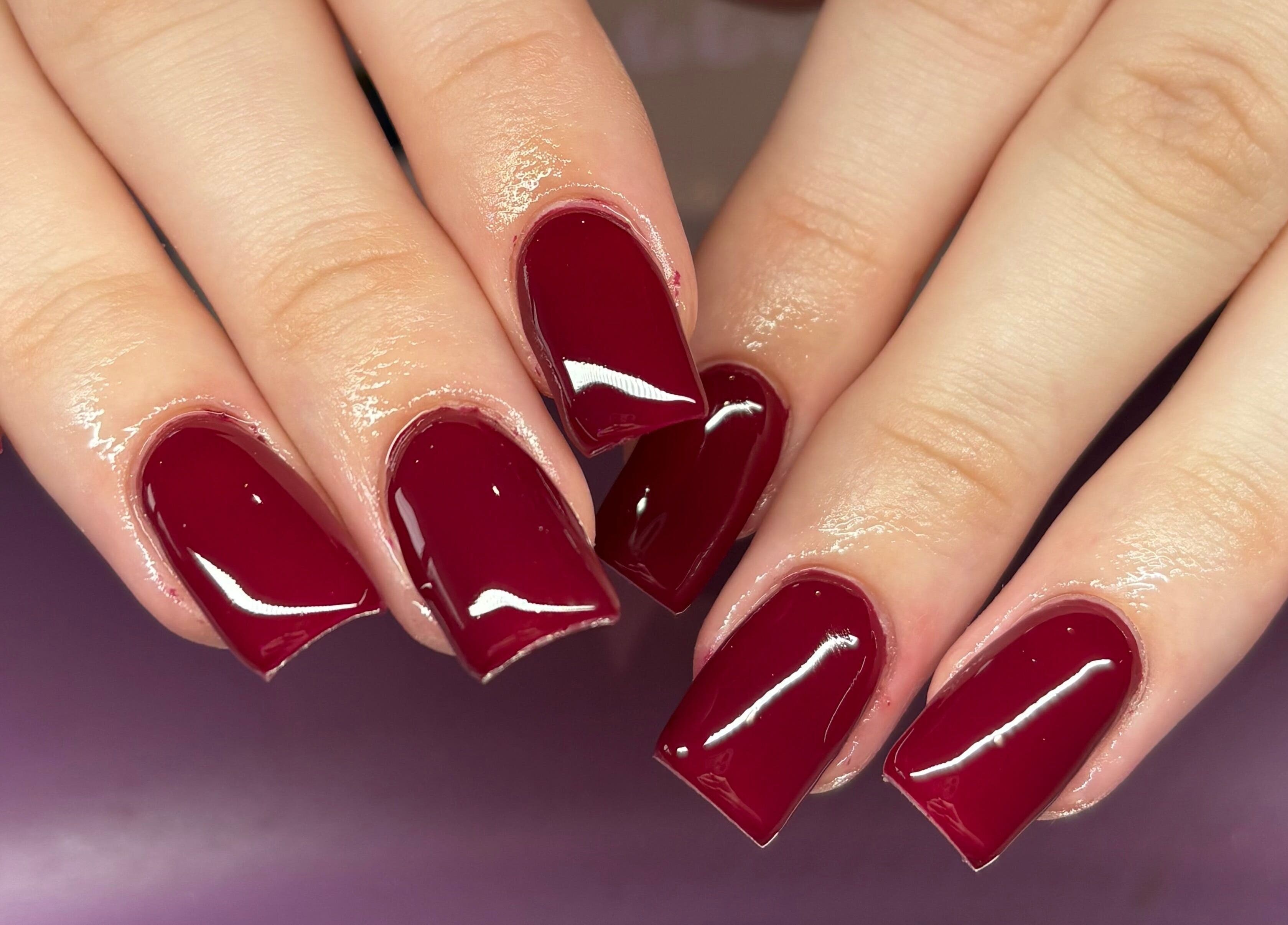 Elegant red acrylic nails at Nails By Molly, Maxey, England, GB. Perfectly styled for a chic look.