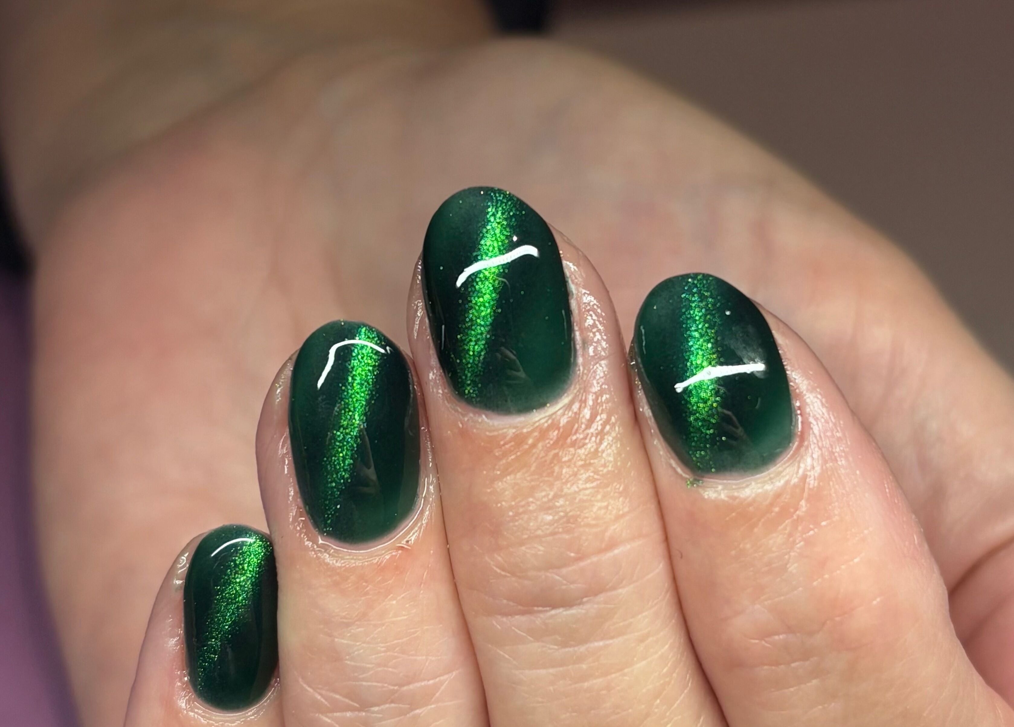 Shiny emerald nails at Nails By Molly, Maxey, England, GB showcasing expert nail art.