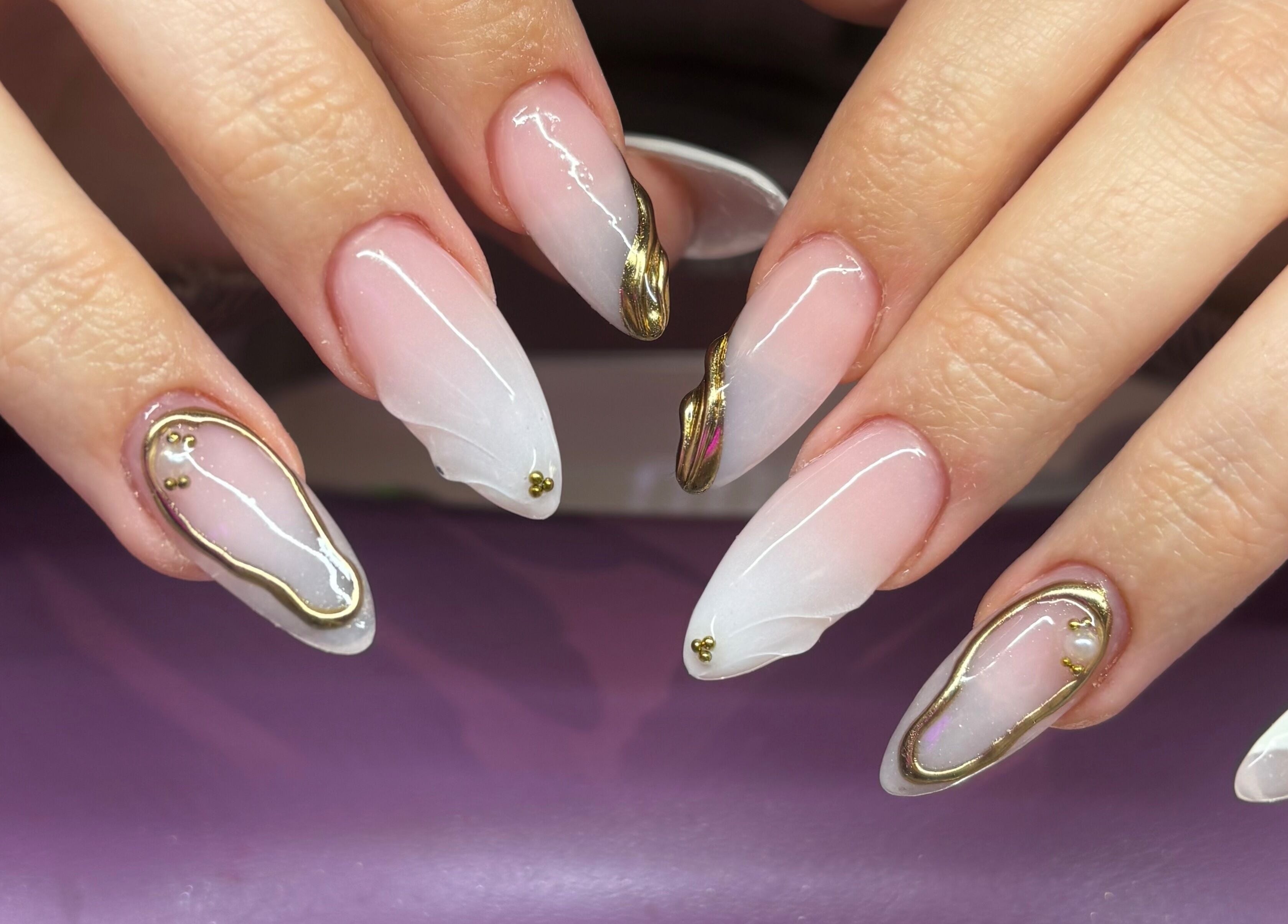 Elegant nail art with gold accents at Nails By Molly in Maxey, England, GB.