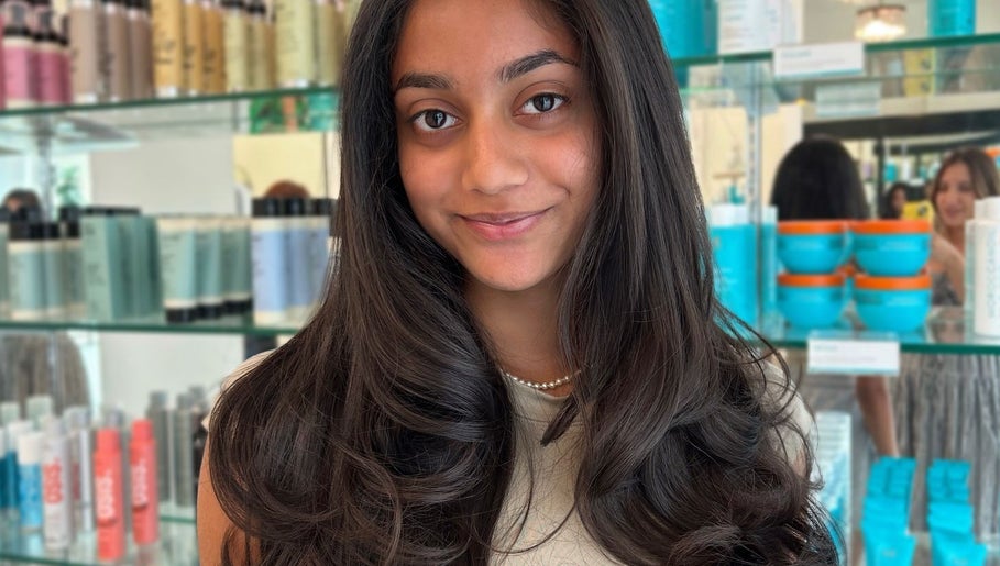 Smiling woman showcasing silky hair at Premier Hair Centre, Toronto, Ontario, CA.