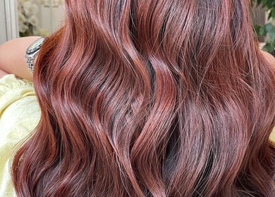 Glossy auburn hair waves styled at Premier Hair Centre in Toronto, Ontario, CA for a radiant look.