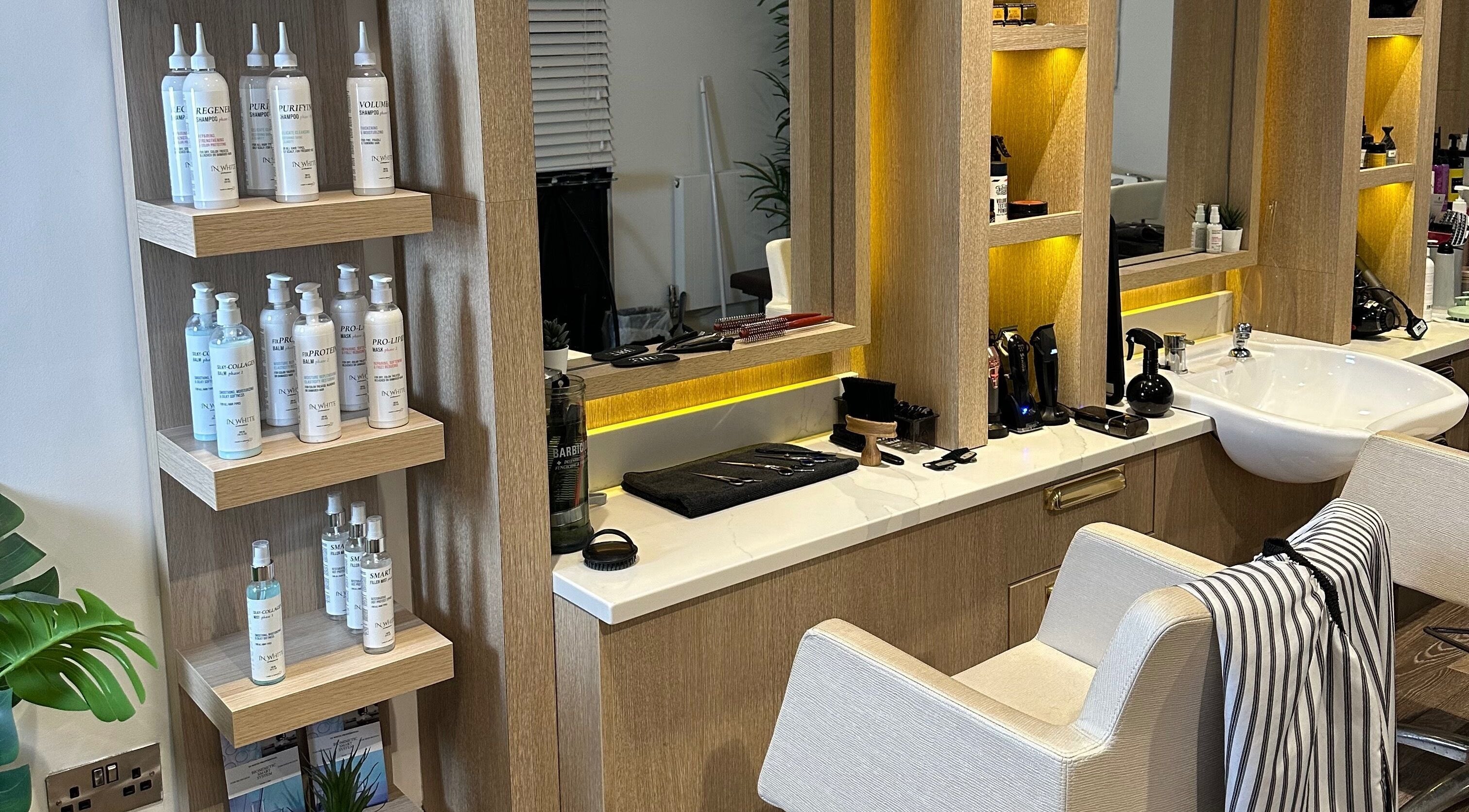 Modern styling station at Jason Parry Barbering, Tattenhall, England, GB showcasing premium hair products.