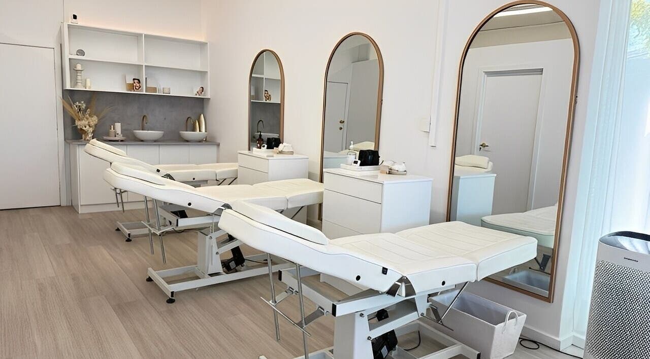 Elegant spa room at Queen Brows and Skin - Doncaster East, Melbourne, Victoria, AU with treatment beds and mirrors.