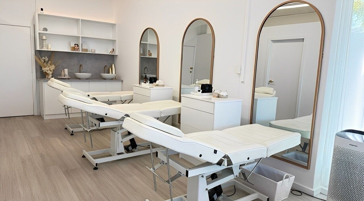 Elegant spa room at Queen Brows and Skin - Doncaster East, Melbourne, Victoria, AU with treatment beds and mirrors.