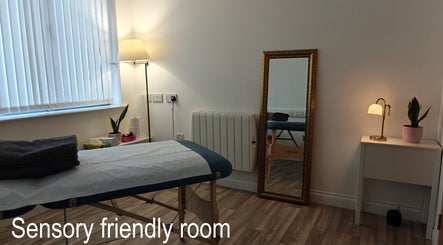 Tranquil therapy room at LG Holistic, Limerick, County Limerick, IE, with a massage table and cozy ambiance.