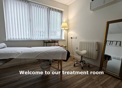 Calming treatment room at LGholistic in Limerick, County Limerick, IE, featuring a serene massage table and warm lighting.