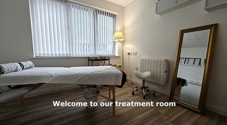 Calming treatment room at LGholistic in Limerick, County Limerick, IE, featuring a serene massage table and warm lighting.