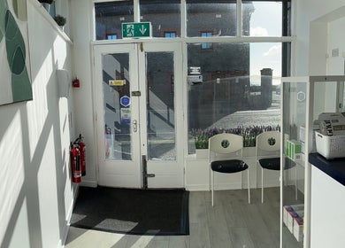 Bright entrance at Blackrock Podiatry Clinic, Dundalk, County Louth, IE with seating and clinical products.