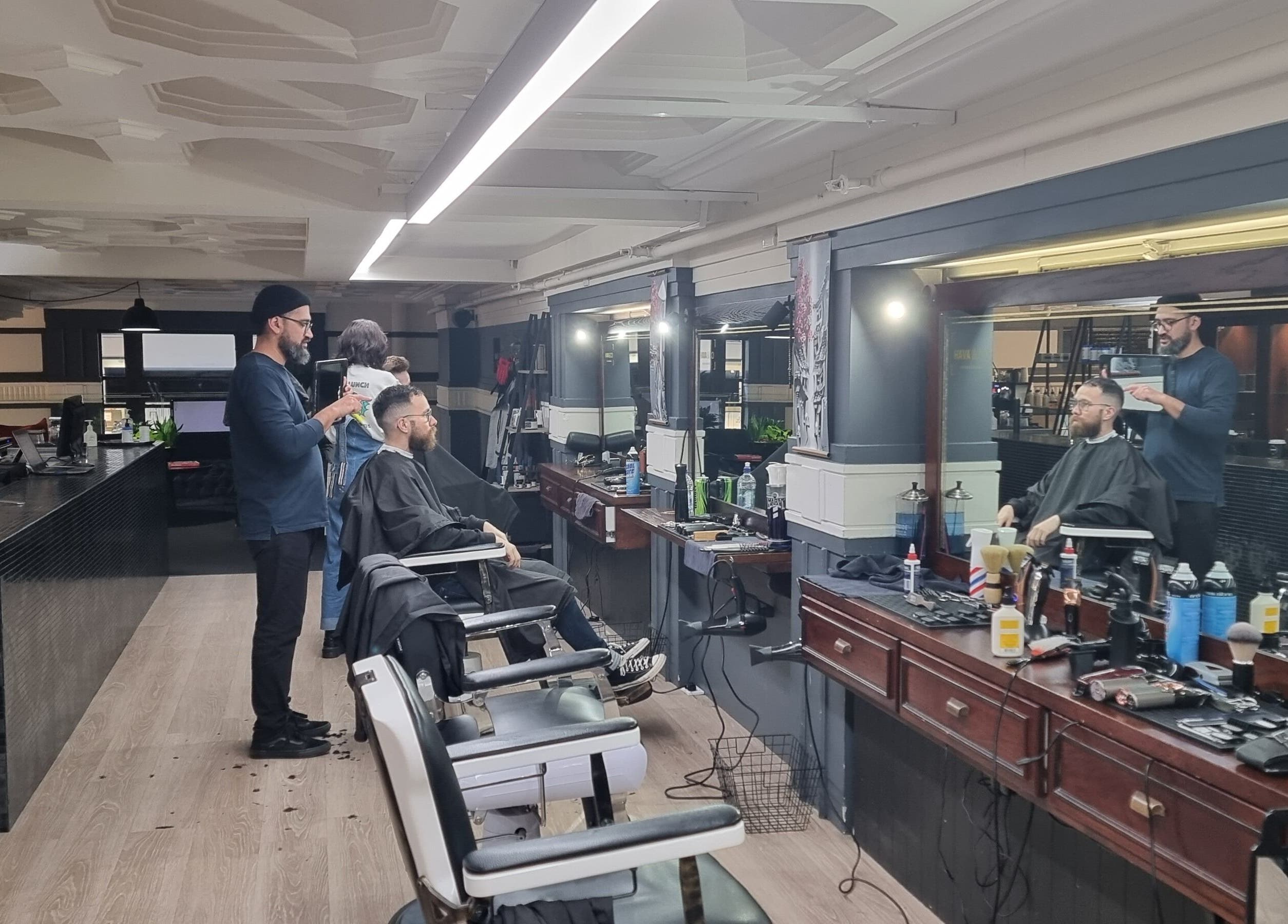 Hairdresser styling a client's hair at Hava & Co in Auckland, Auckland, NZ. Modern salon setup.