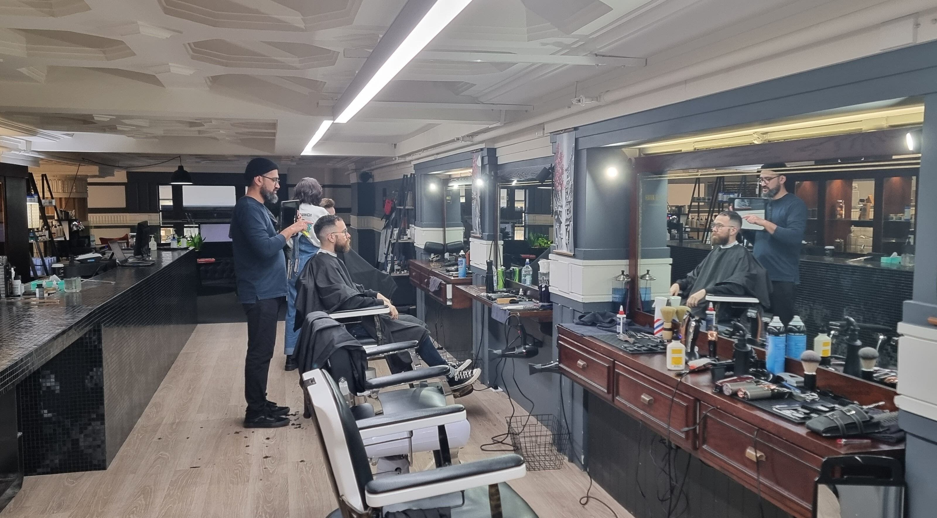 Hairdresser styling a client's hair at Hava & Co in Auckland, Auckland, NZ. Modern salon setup.