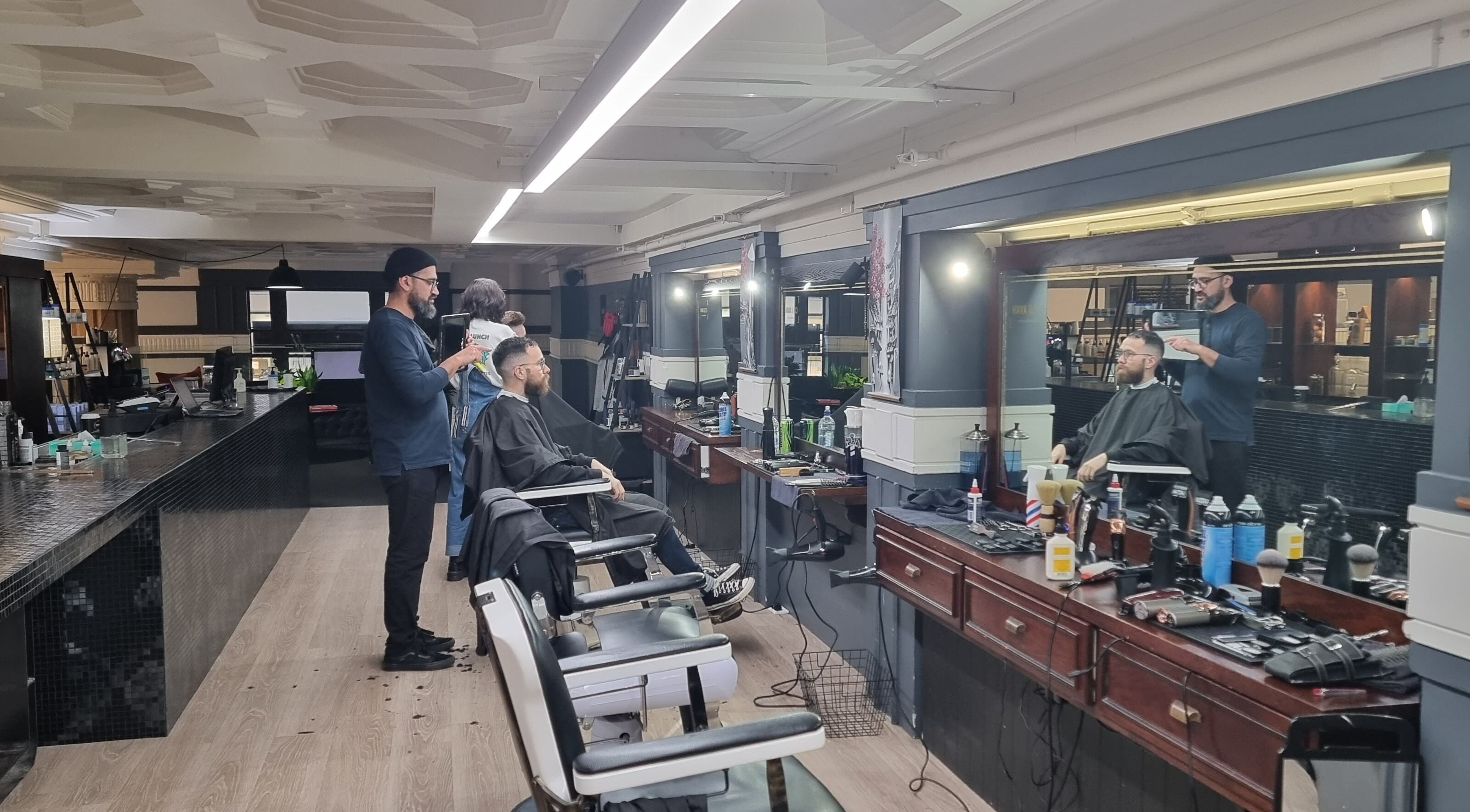 Hairdresser styling a client's hair at Hava & Co in Auckland, Auckland, NZ. Modern salon setup.