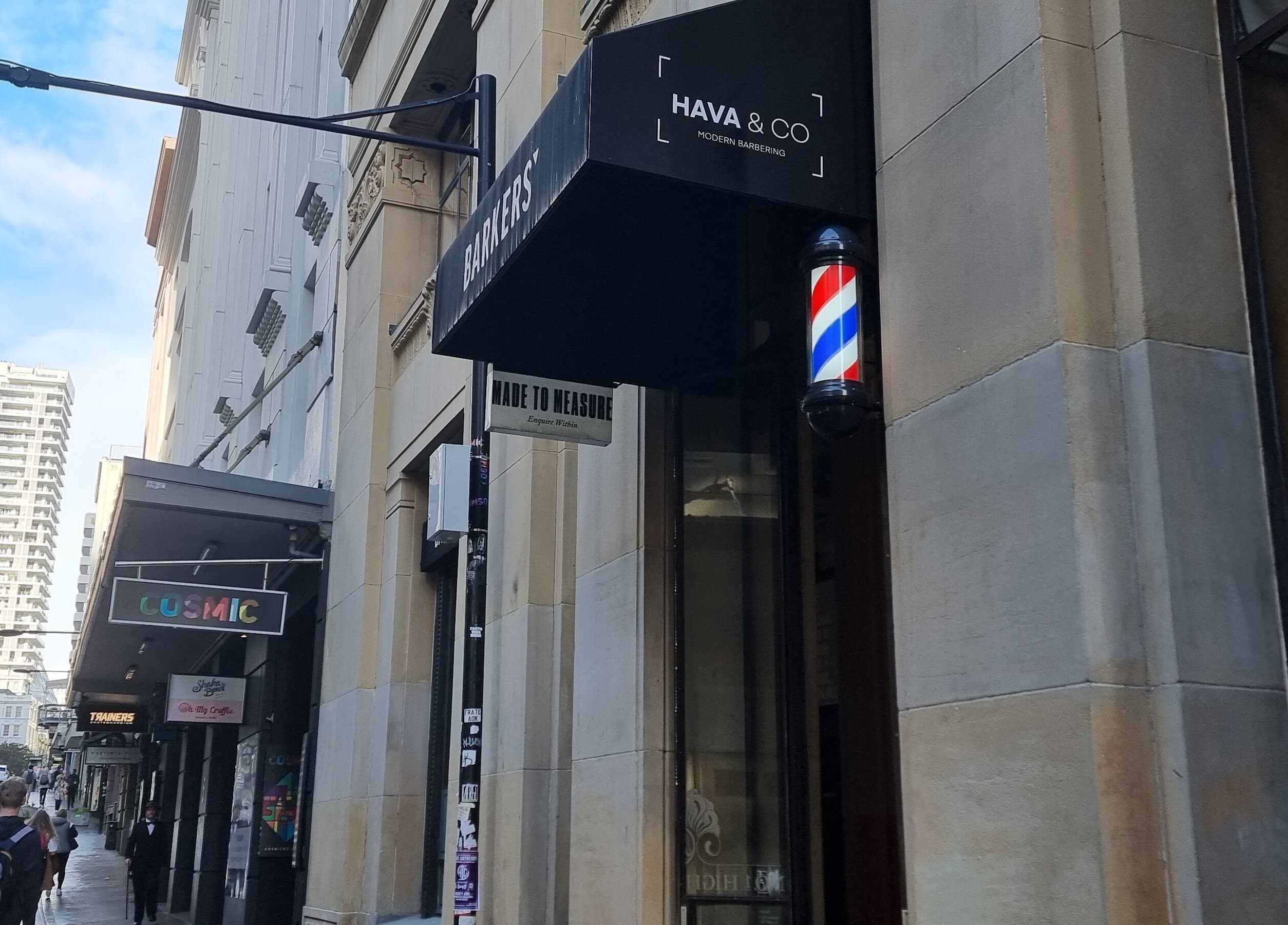 Entrance of Hava & Co barbershop on a bustling street in Auckland, Auckland, NZ.