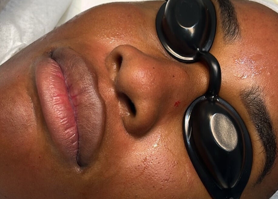 Client relaxing during a facial at Rm Lashes, London, England, GB, highlighting skin rejuvenation treatment.