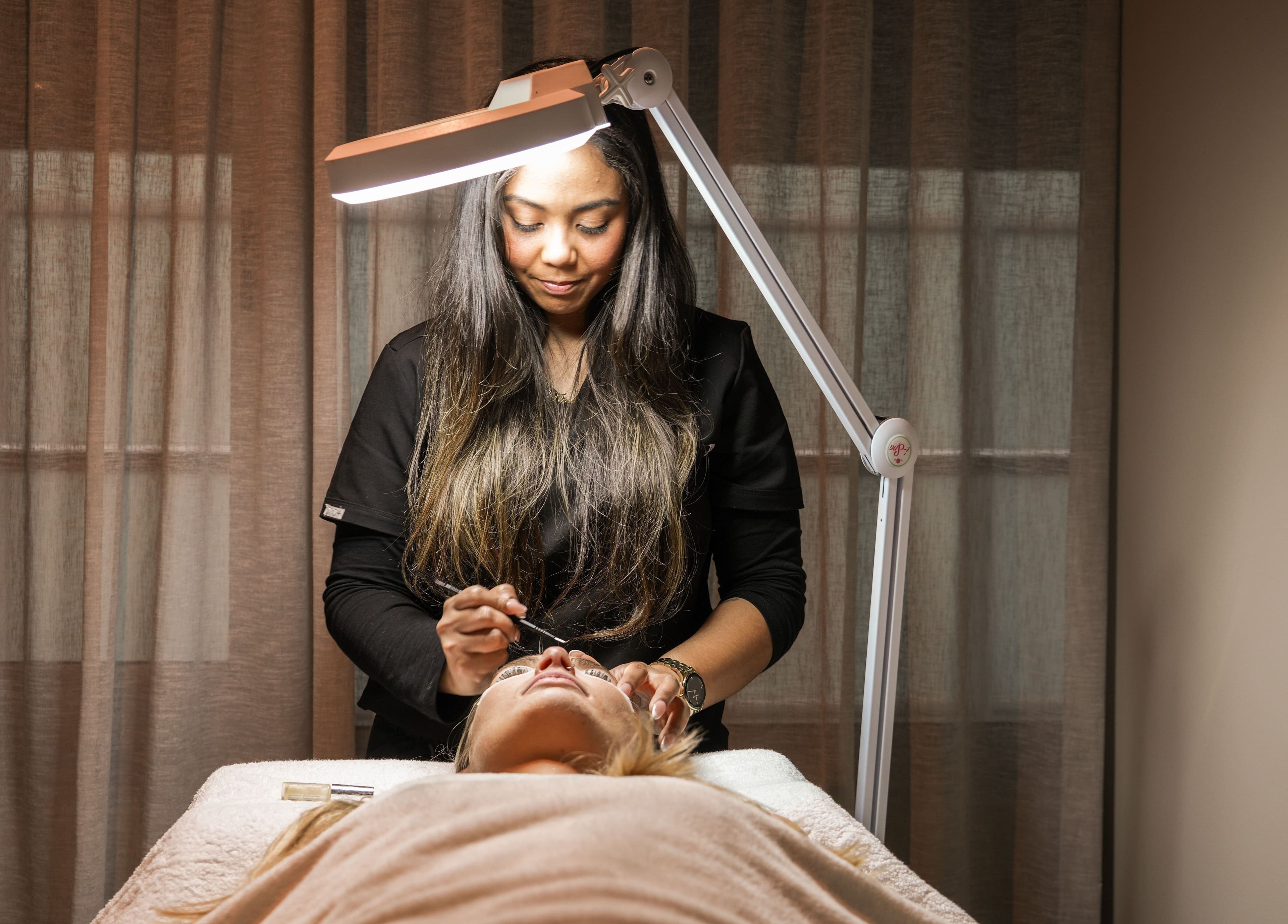 Aesthetician performing a facial at Novaderm Aesthetics, Cape Town, Western Cape, ZA.