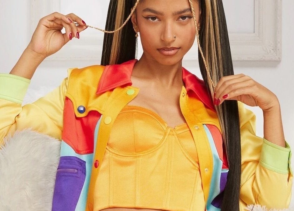 Stylish individual with colorful attire, showcasing Undivided Hair Studio, Houston, Texas, US.