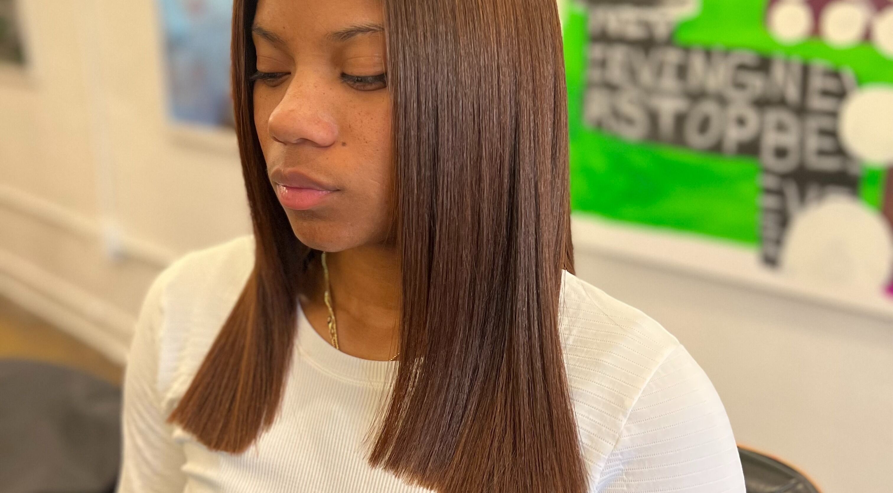 Smooth brown hair styling at Undivided Hair Studio, Houston, Texas, US, showcasing sleek beauty expertise.