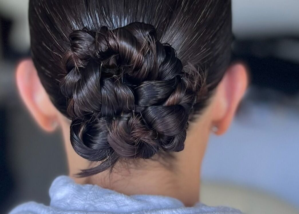 Intricate braided hairstyle at Undivided Hair Studio, Houston, Texas, US. Perfect for elegant occasions.