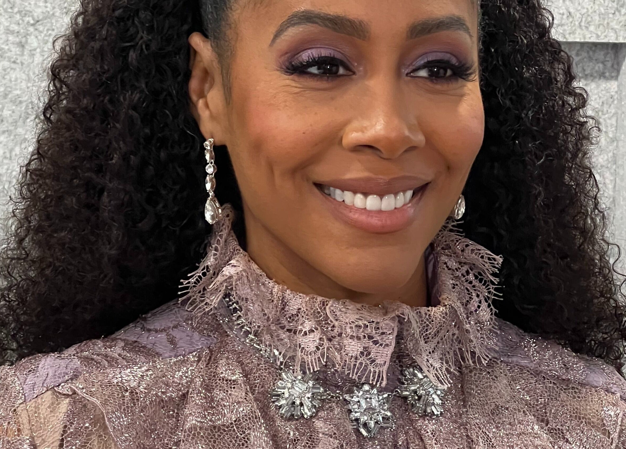 Elegant hairstyle at Undivided Hair Studio in Houston, Texas. Highlighting radiant curls and chic accessories.