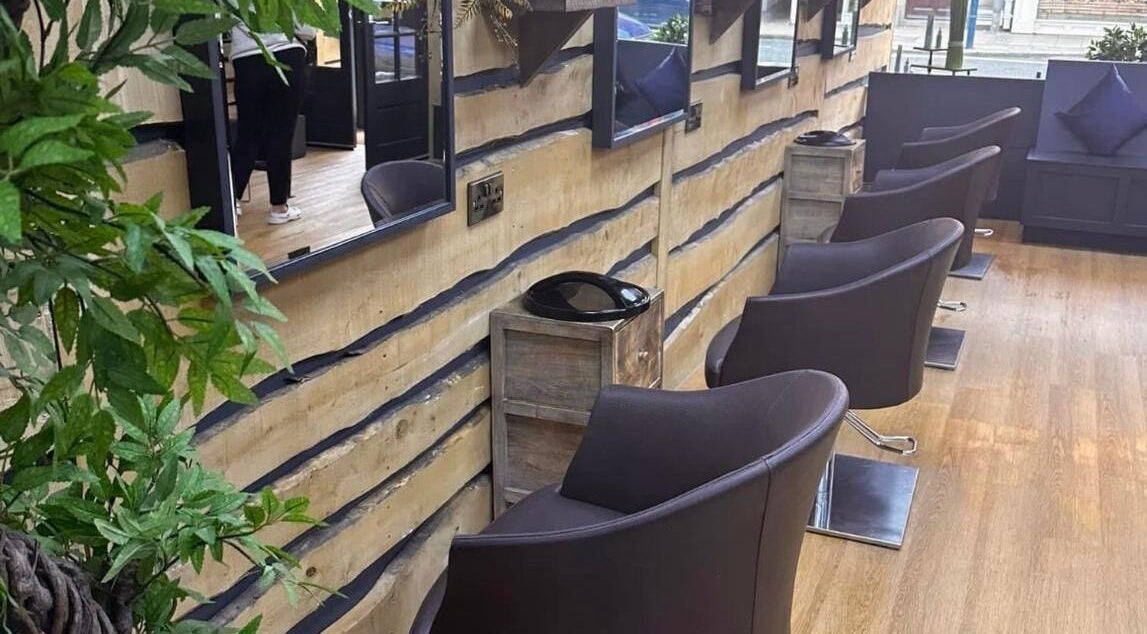 Modern salon interior at Claire Brown hairdressing, Newcastle upon Tyne, England, with stylish chairs and decor.