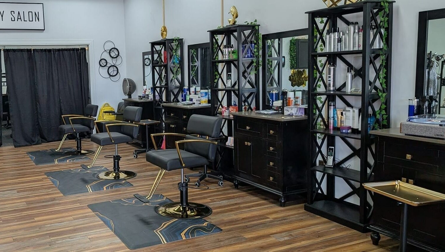 Chic interior of Legacy Salon in Warrensburg, Missouri, US featuring stylish black chairs and beauty products.
