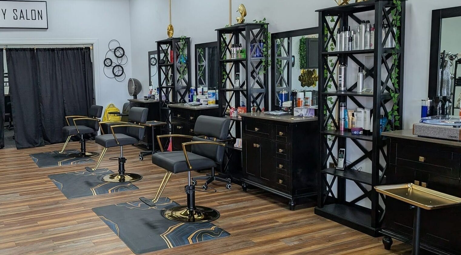 Chic interior of Legacy Salon in Warrensburg, Missouri, US featuring stylish black chairs and beauty products.
