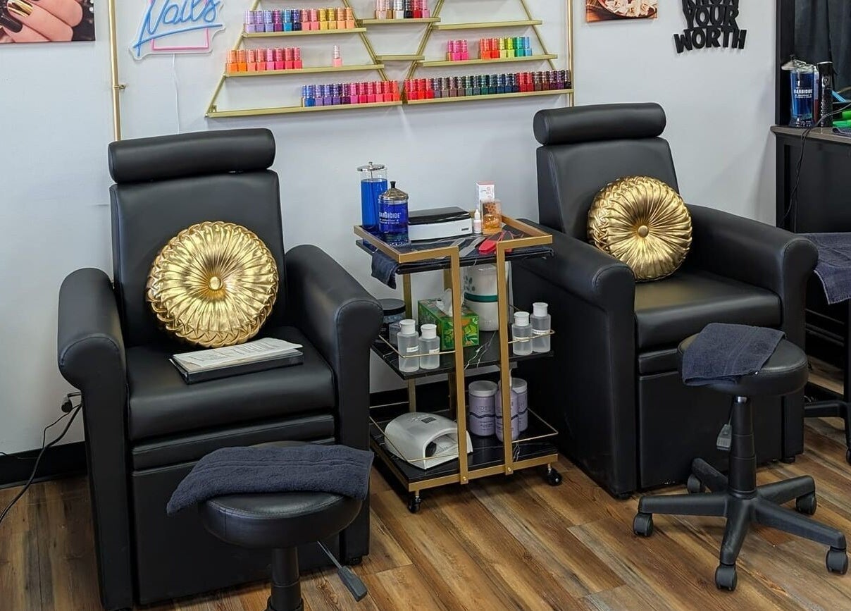 Elegant nail lounge at Legacy Salon, Warrensburg, Missouri, US with black chairs and gold accents.