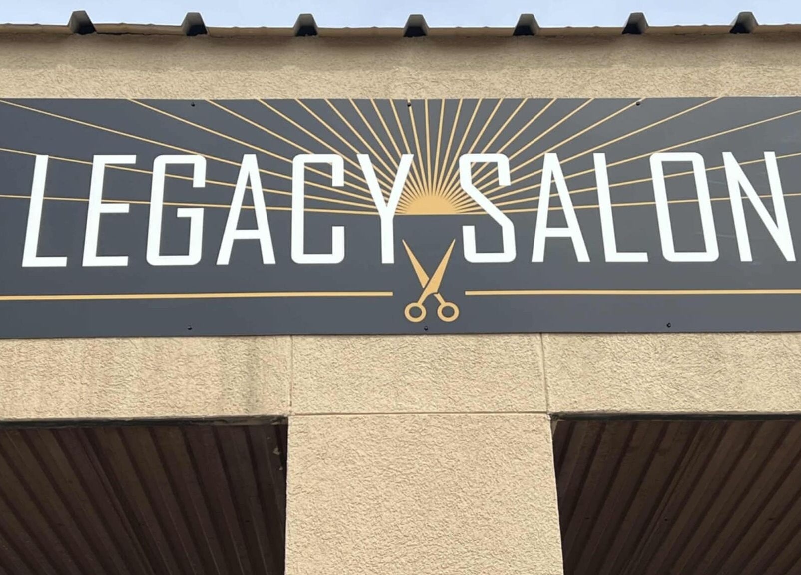 Legacy Salon entrance sign in Warrensburg, Missouri, US with elegant scissors logo.