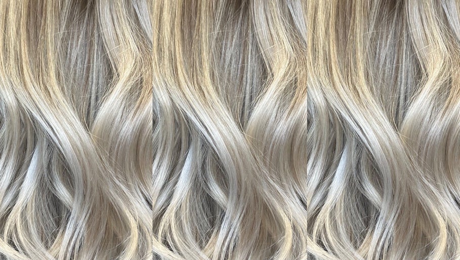 Elegant blonde waves styled at KG Hair, Newport, Wales, GB, showcasing a luxurious finish.