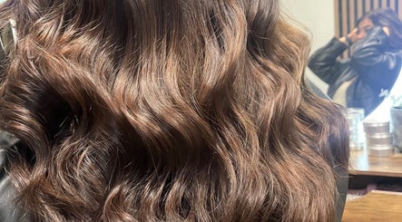 Shiny, wavy brown hair at KG Hair salon, Newport, Wales, GB, reflecting expert styling.