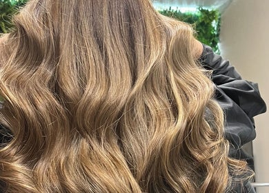 Luxurious brunette waves styled at KG Hair, Newport, Wales, GB, enhancing natural beauty and elegance.