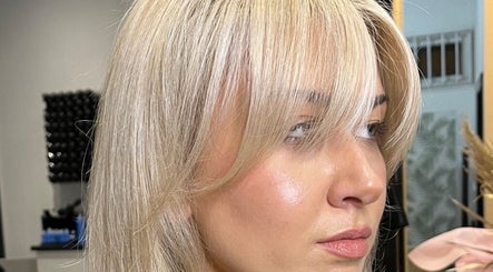 Close-up of blonde hairstyle at KG Hair salon in Newport, Wales, GB, showcasing sleek and shiny locks.