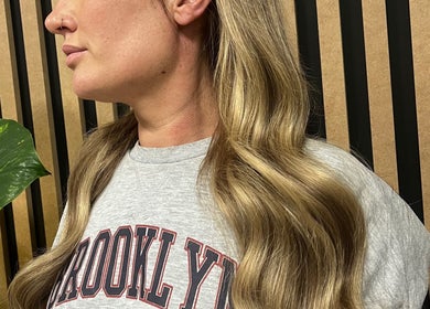 Wavy blonde hair styled at KG Hair, Newport, Wales, GB. Elegant and refined salon look.